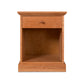 A Lyndon Furniture New England Shaker 1-Drawer Enclosed Shelf Nightstand, characterized by its small size and crafted from luxurious wood materials.