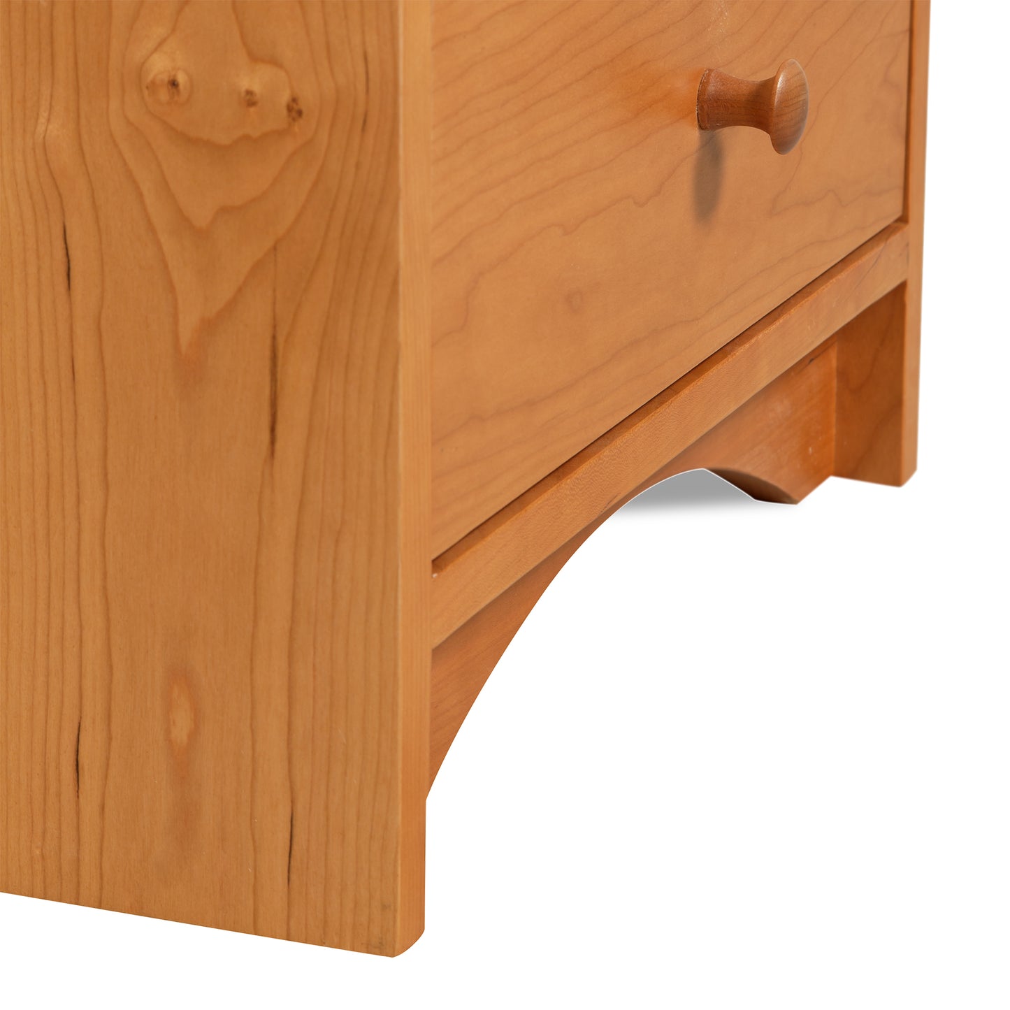 A close up of a Lyndon Furniture New England Shaker 3-Drawer Nightstand with Arched Base.