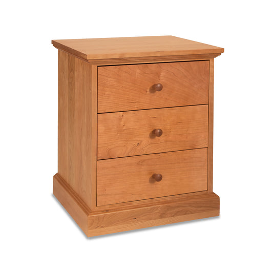 Lyndon Furniture New England Shaker 3-Drawer Nightstand made of cherry wood with three drawers.