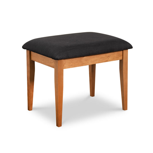 New England Shaker dressing stool by Lyndon Furniture, handcrafted in Vermont with four wooden legs and a black cushioned seat.