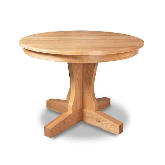 New Traditions Round Pedestal Extension Table in Oak by Lyndon Furniture – handcrafted solid wood with a central pedestal base, traditional American Mission style.