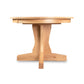 New Traditions Round Pedestal Extension Table by Lyndon Furniture, handcrafted in oak with a round top and elegant pedestal base, showcasing classic American Mission style. Made in Vermont, USA.