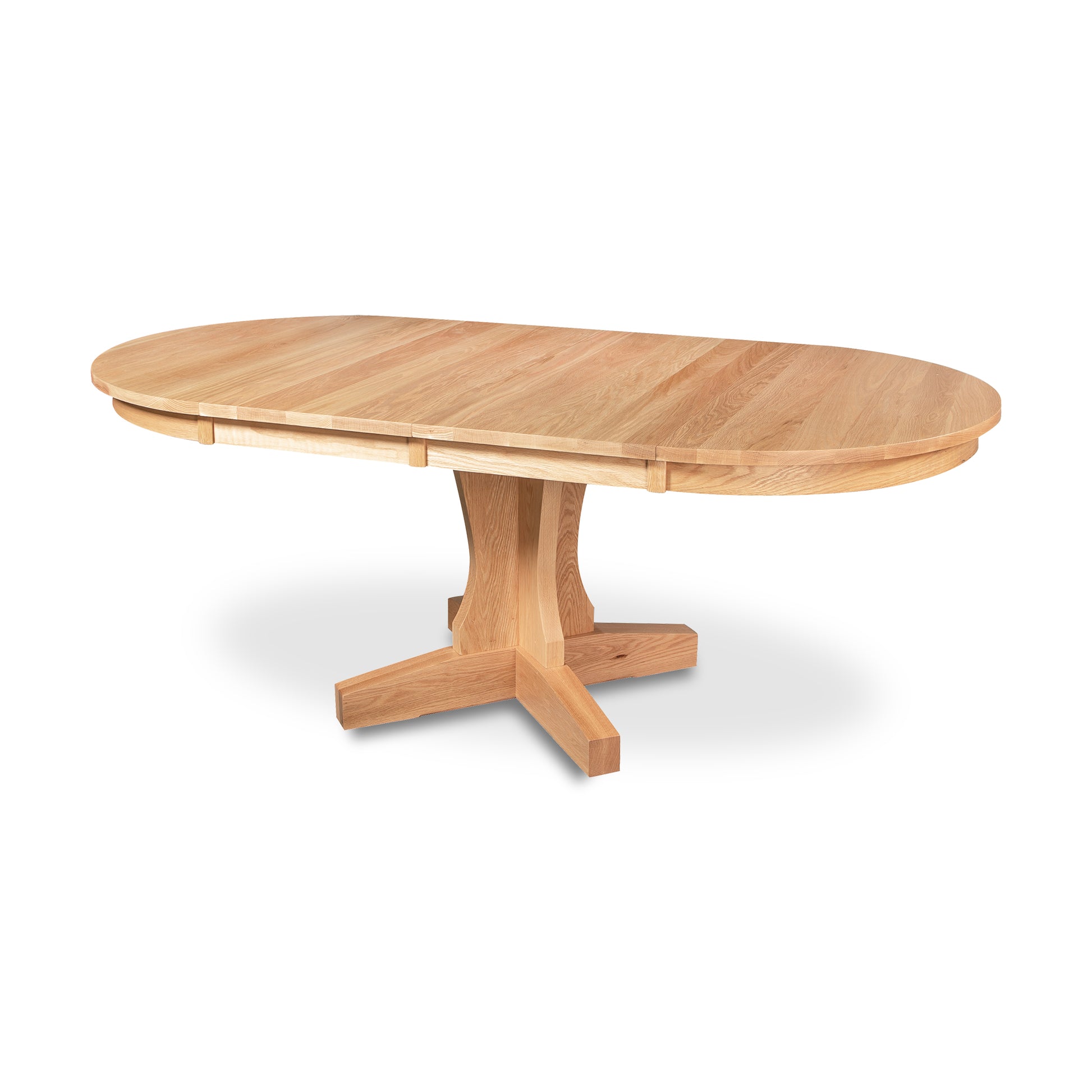 New Traditions Round Pedestal Extension Table by Lyndon Furniture made from oak with a natural finish, showcasing handcrafted Vermont solid wood craftsmanship.