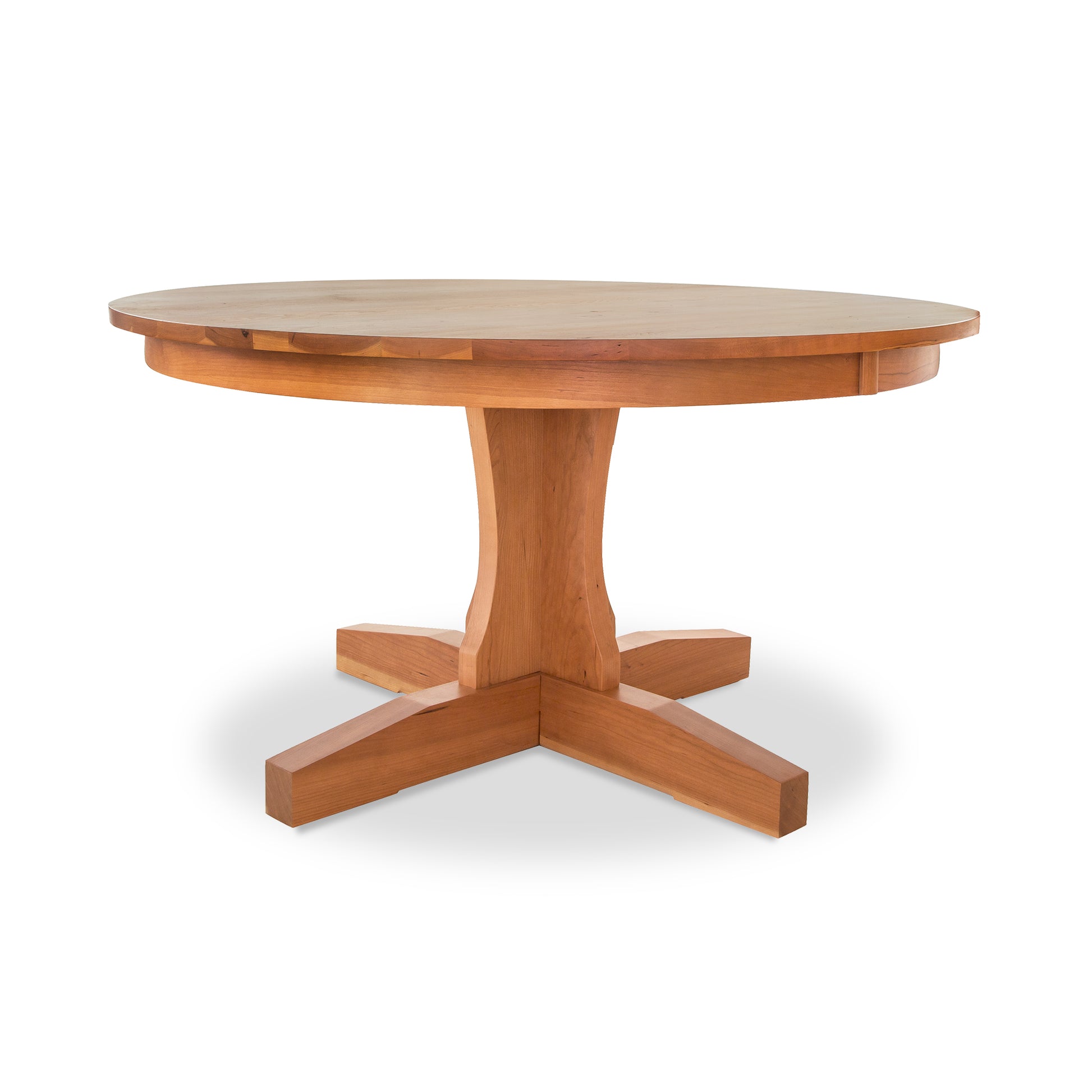 A New Traditions Round Pedestal Table by Lyndon Furniture, with a wooden base, crafted from hardwoods and finished with a natural finish.