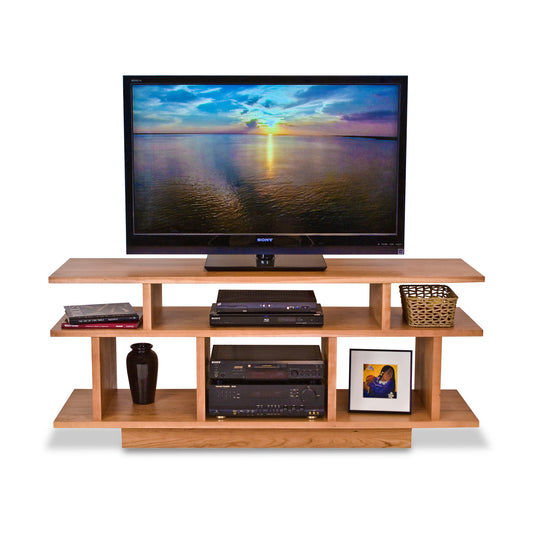 A Lyndon Furniture New York Contemporary TV Stand #1 showcasing a flat screen TV on top, along with media equipment.