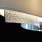 A close up of the Hubbardton Forge Oceanus Pendant lighting fixture with a chrome finish.