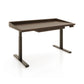 Copeland Furniture Odin Sit-Stand Desk with rich brown finish, sturdy metal legs, raised edge detail, and a convenient right-side control panel.
