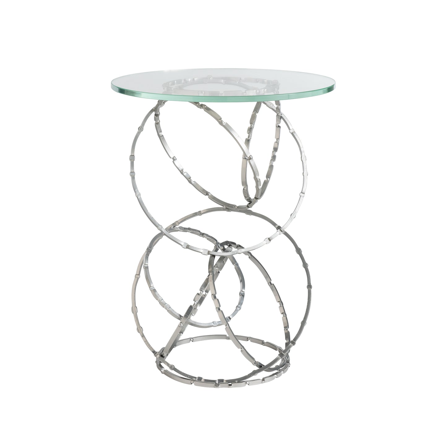 The Olympus Glass Top Accent Table by Hubbardton Forge features a clear, round glass surface supported by a polished metal base of interconnected circular loops, creating a modern and artistic design perfect for contemporary homes.