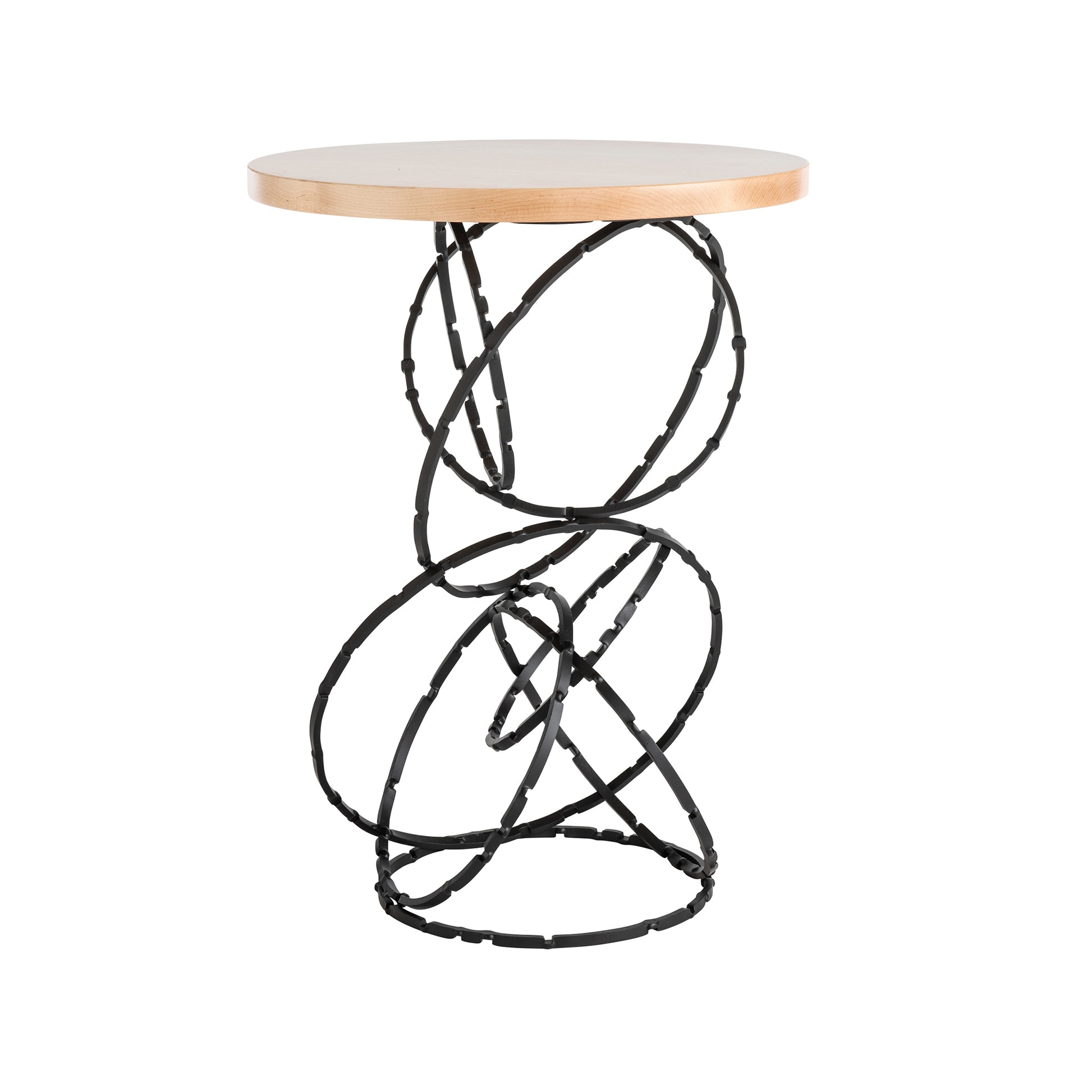 The Olympus Wood Top Accent Table by Hubbardton Forge showcases a round Vermont maple wood top and an artistic base made of intertwined black metal loops, resulting in a unique sculptural design.