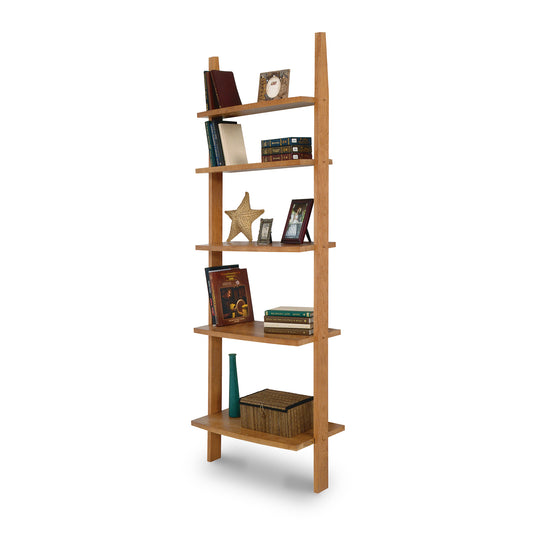 Solid wood ladder bookcase by Lyndon Furniture with five hand-crafted shelves for books, picture frames, and decor. American made light wood open bookshelf on white background.