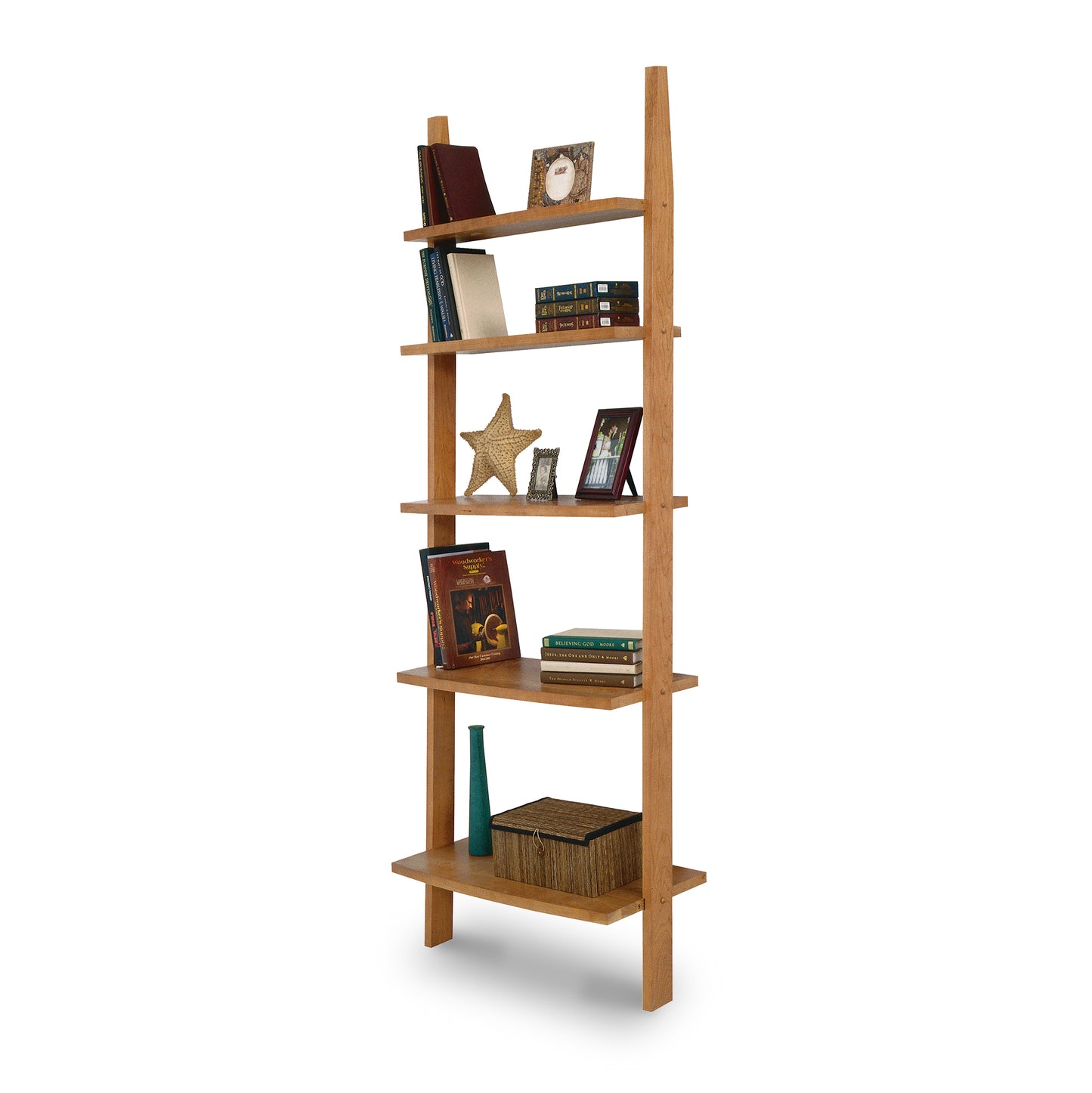 A Lyndon Furniture Open Ladder Bookcase with shelves filled with books.