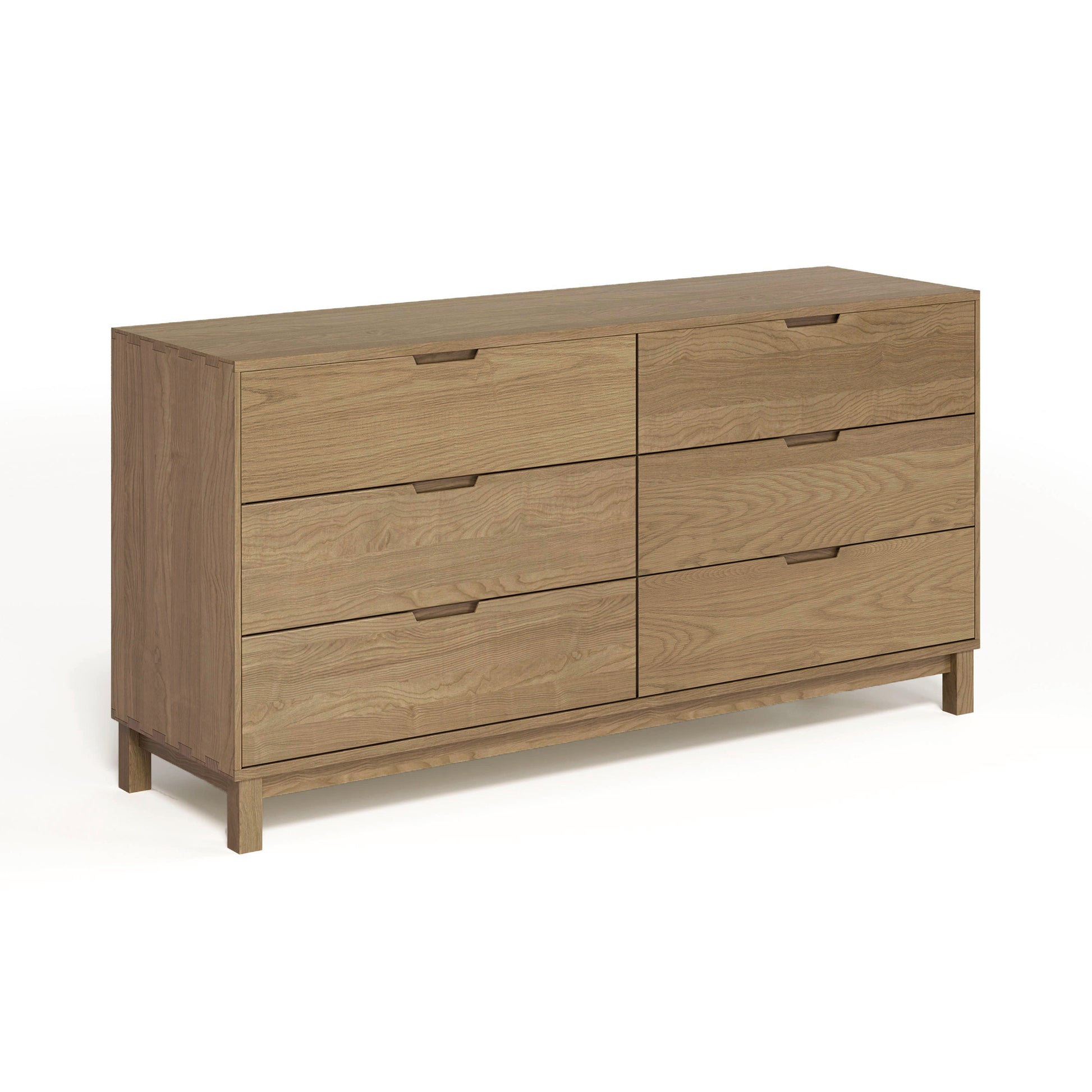 The Copeland Furniture Oslo 6-Drawer Dresser is a stunning piece made of solid natural oak hardwood, offering ample bedroom storage. This exquisite wooden dresser stands out on any white background.