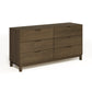 The Copeland Furniture Oslo 6-Drawer Dresser is a solid natural oak hardwood piece of furniture that offers ample bedroom storage. It features a dark brown color, contrasting beautifully against the white background.