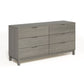 The Copeland Furniture Oslo 6-Drawer Dresser is a solid natural oak hardwood dresser that provides ample bedroom storage. With its grey color and drawers, it stands out against a pristine white background.