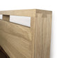 Sentence with replaced product: Close-up of a solid oak hardwood headboard with a focus on the corner joint detail, part of the Copeland Furniture's Oslo Platform Bed collection.