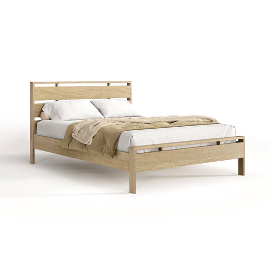 A solid oak hardwood bed frame from Copeland Furniture, with a headboard featuring light-colored bedding and a tan throw blanket in a white studio setting, known as the Copeland Furniture Oslo Platform Bed.