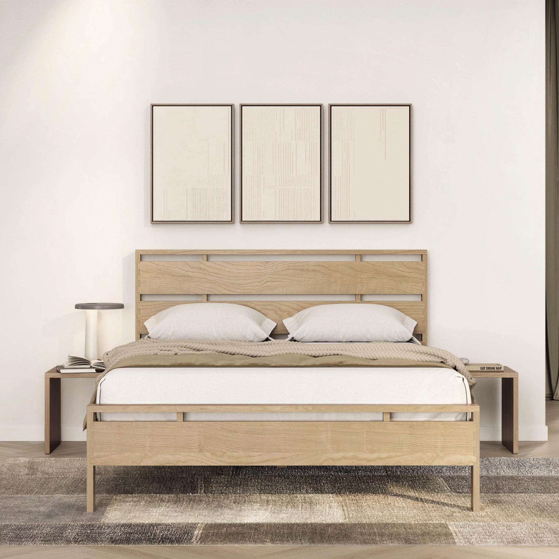 A neat and modern bedroom with a double Oslo Platform Bed by Copeland Furniture, two pillows, and a three-piece wall art above the headboard.