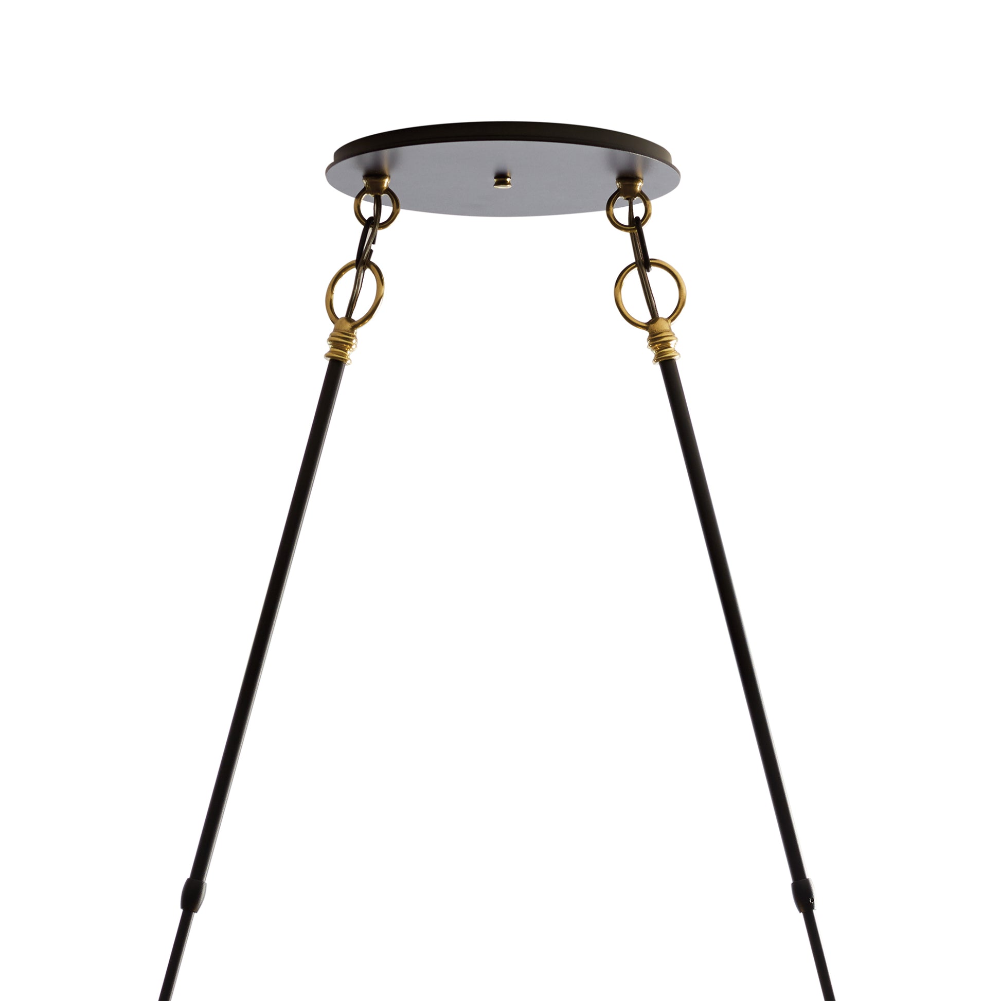 A black and gold Hubbardton Forge Otto Sphere Pendant with two legs.