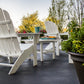 White POLYWOOD Adirondack chairs and a matching 38" Conversation Table arranged together, showcasing premium American-made outdoor furniture.