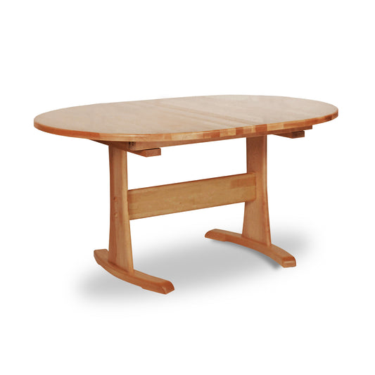 A sustainably harvested Oval Trestle Extension Table #2 by Lyndon Furniture with a handmade wooden top and legs.