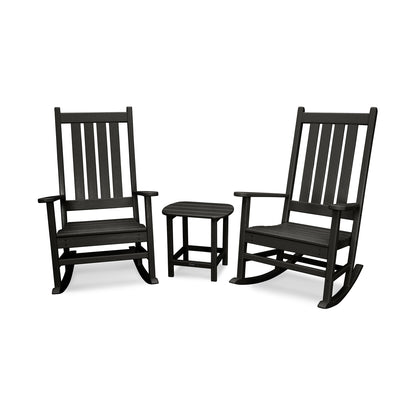Two black POLYWOOD® Vineyard Porch Rocking Chairs and a small matching side table set on a plain white background. The chairs exhibit a classic slatted design with curved bases for rocking and.
