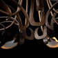 Curved, hand-forged steel arms and bronze detailing on the Parasol 7-Light Chandelier by Hubbardton Forge, showcasing its elegant craftsmanship.