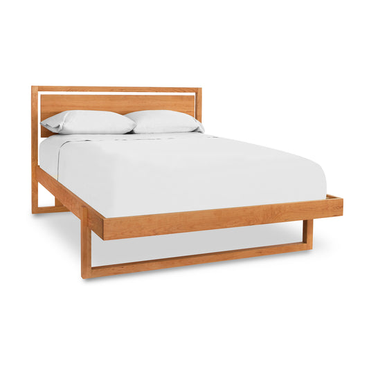 A modern Pendant Bed made with sustainable wood and adorned with white sheets by Vermont Furniture Designs.
