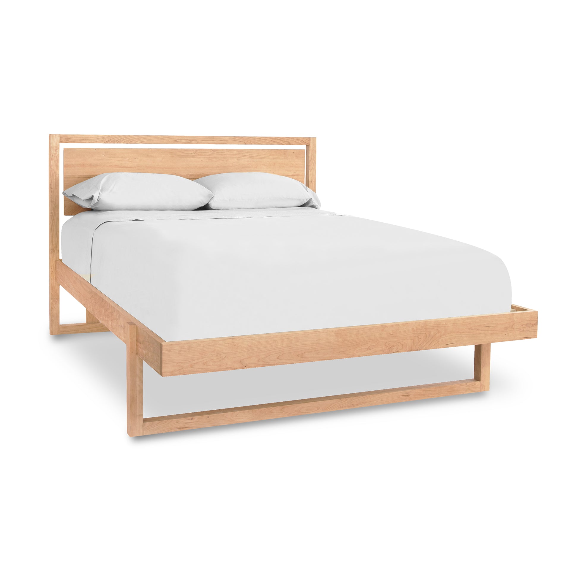 Minimalist wooden bed frame, The Pendant Bed by Vermont Furniture Designs, crafted from sustainably harvested cherry wood.