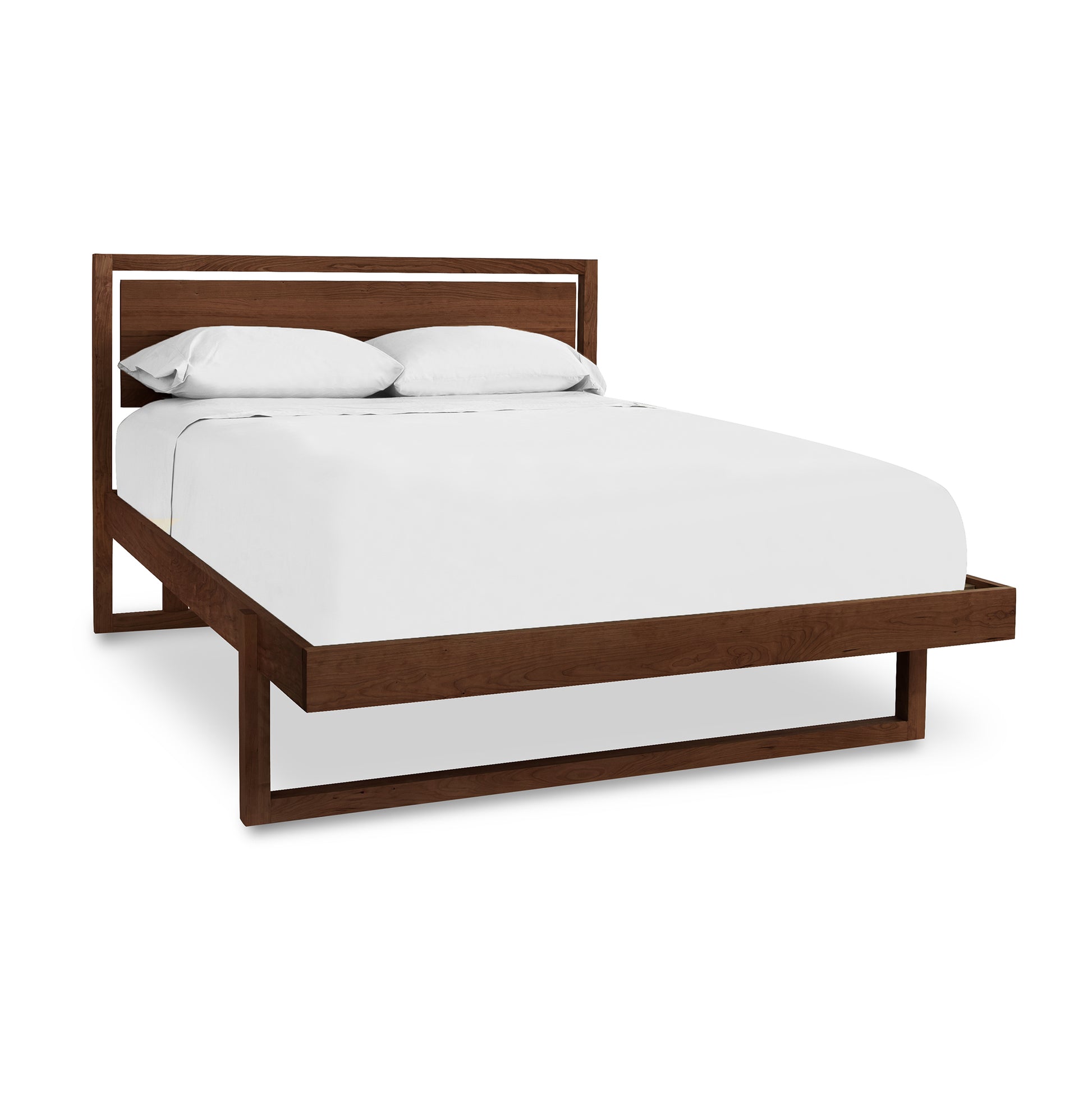 Modern cherry wood frame Pendant Bed by Vermont Furniture Designs with white mattress and pillows.