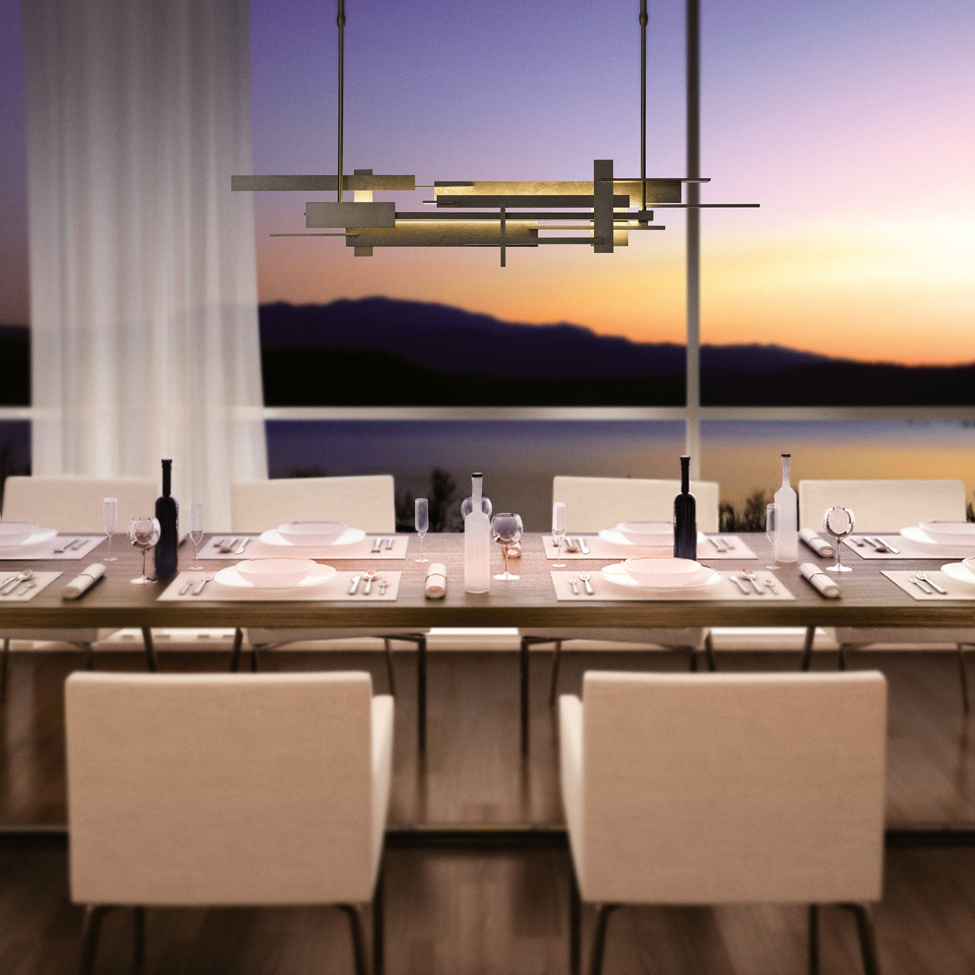 Modern American-made dining set for 8 featuring neutral chairs, highlighted by a Hubbardton Forge Planar LED Pendant.