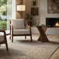 Beige armchair and Copeland Planes glass end table, crafted in the USA, are featured as the focal furniture pieces in a modern living room.