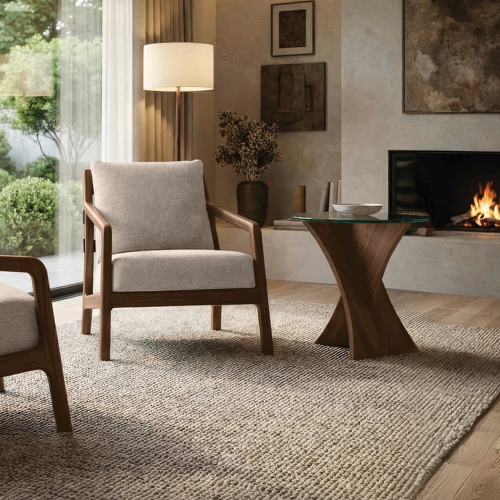 Beige armchair and Copeland Planes glass end table, crafted in the USA, are featured as the focal furniture pieces in a modern living room.