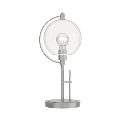 Pluto Table Lamp by Hubbardton Forge with silver handcrafted base, glass globe, and exposed bulb, showcasing modern Vermont-made craftsmanship.