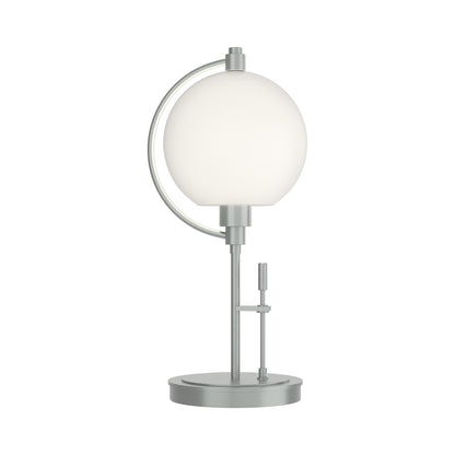 Pluto Table Lamp by Hubbardton Forge with a spherical white glass shade and sleek metallic base, showcasing minimalist American-made craftsmanship.