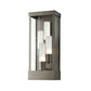 Hubbardton Forge Portico Large Outdoor Sconce with three glass-covered bulbs in Coastal Dark Smoke finish, highlighting its modern craftsmanship.