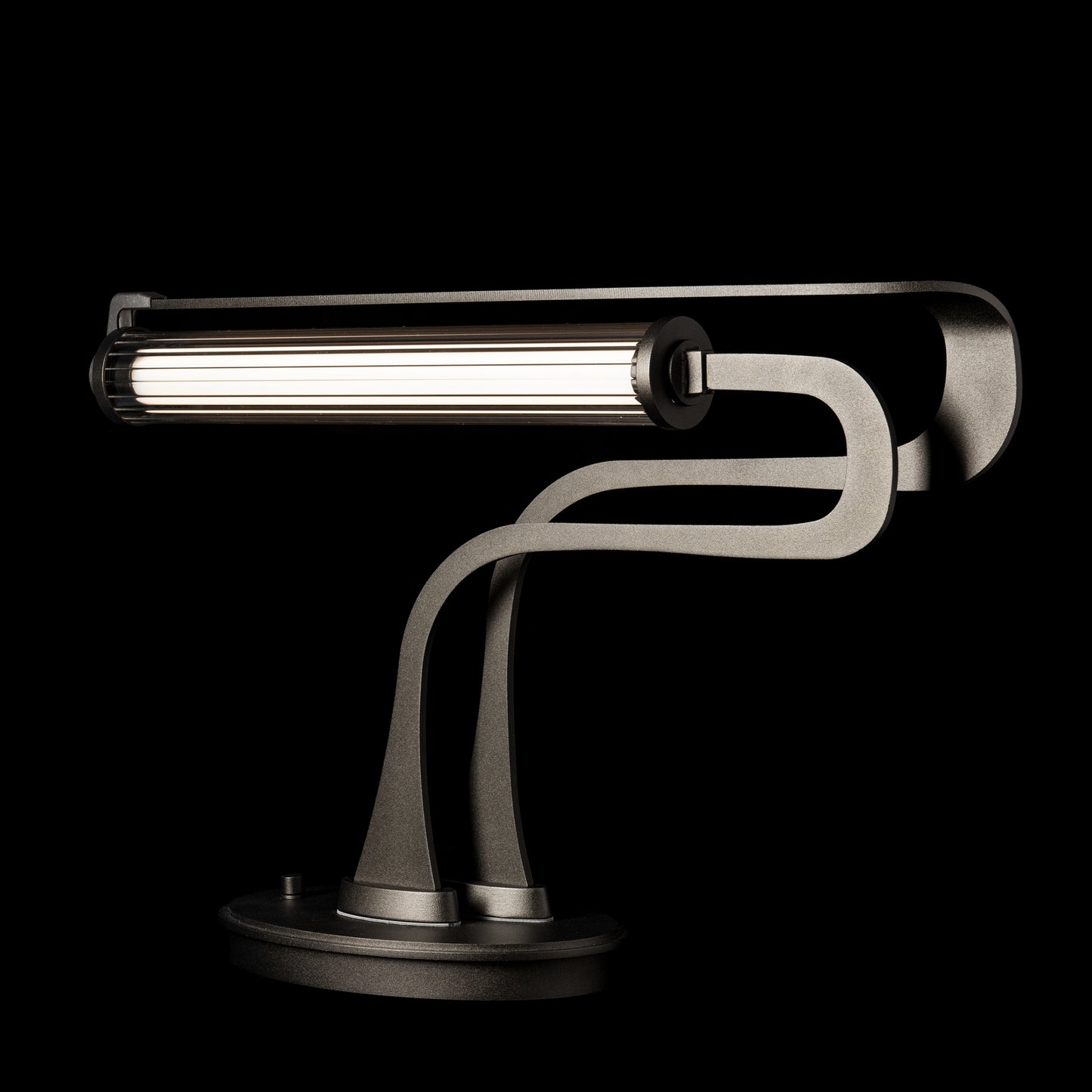 Hubbardton Forge Pulse Table Lamp with a dark metallic design, showcasing a cylindrical light bar and oil-rubbed bronze finish.