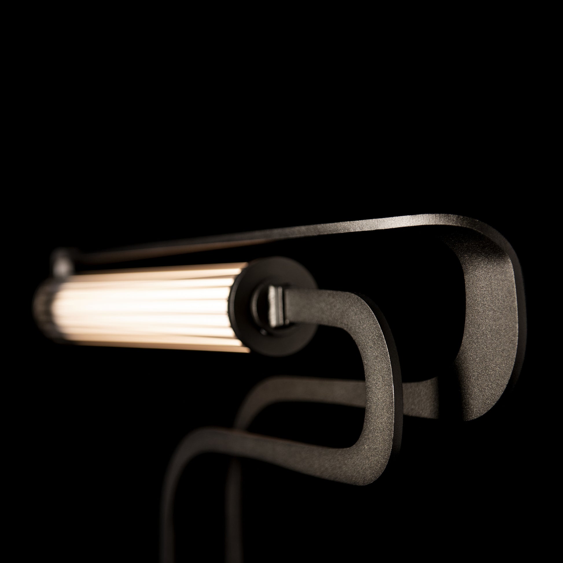 Hubbardton Forge Pulse Table Lamp in contemporary black angular design with tubular illuminated light source and sophisticated Oil Rubbed Bronze finish.