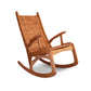 An eco-friendly wooden rocking chair, known as the Quilted Vermont Cherry Rocking Chair, designed for optimal comfort. The brand name of this product is Vermont Folk Rocker.