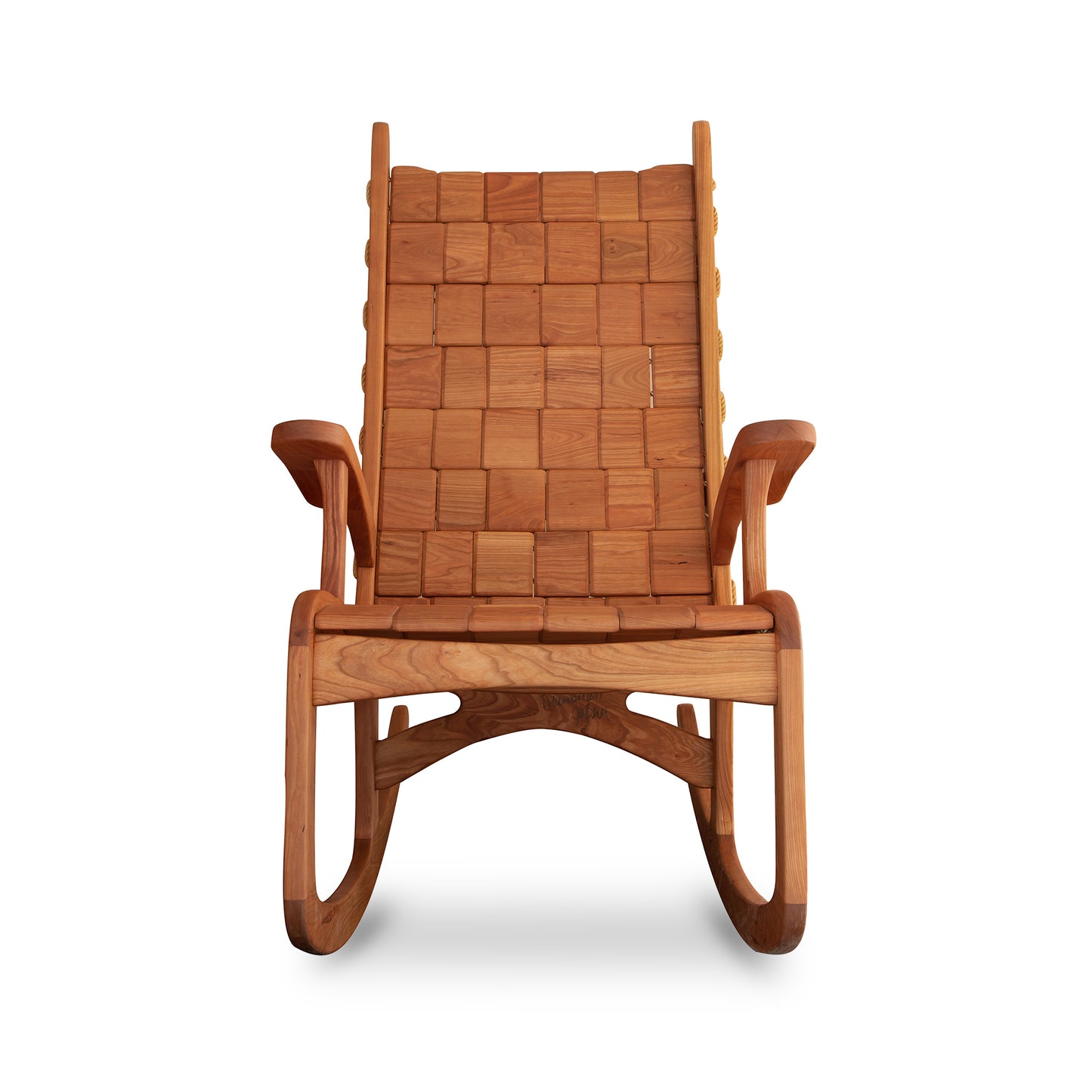 Quilted Vermont Rocking Chair in cherry by Vermont Folk Rocker, featuring a woven backrest and seat with curved armrests and a classic shaker-style design.