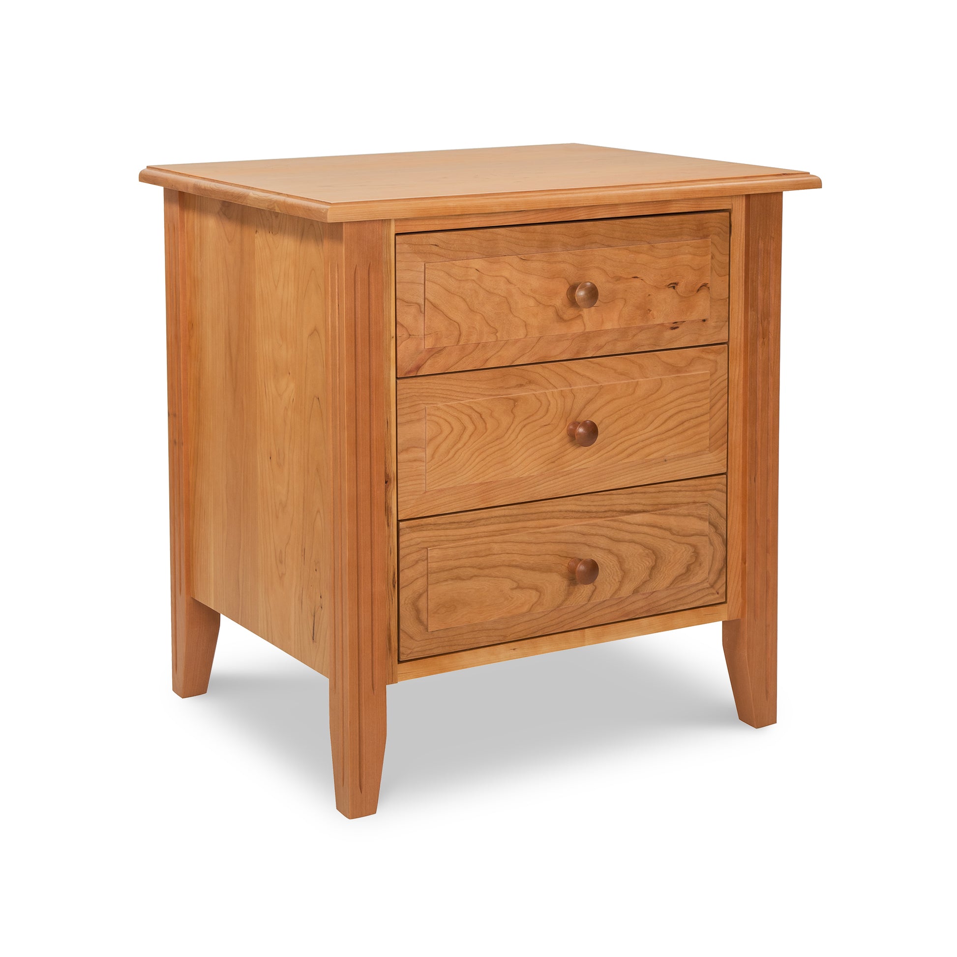 This Renfrew Shaker 3-Drawer Nightstand, exquisitely handmade with top-notch wood, boasts three spacious drawers. It is made by Lyndon Furniture.