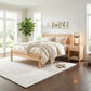 Rockingham Bed by Vermont Woods Studios with matching nightstand, crafted from solid wood, showcased in a bright bedroom with beige bedding.