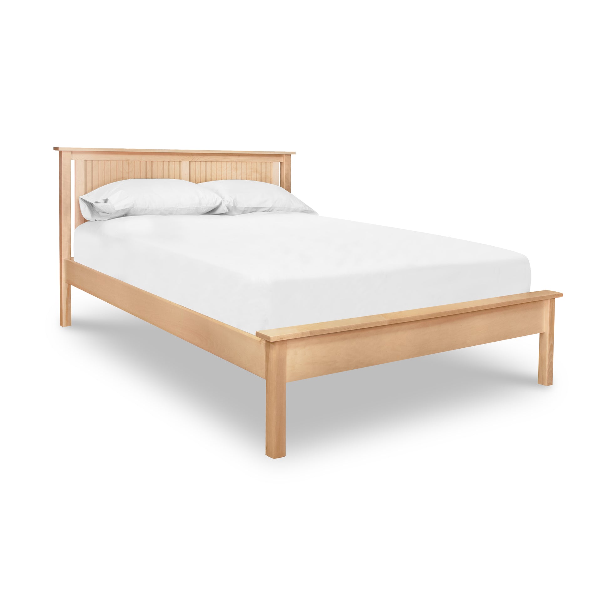 The Rockingham Bed by Vermont Woods Studios showcases a solid wood frame and headboard with crisp white bedding and pillows.