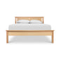 Rockingham Bed by Vermont Woods Studios with a distinctive slatted headboard, shown with crisp white bedding and two matching pillows.