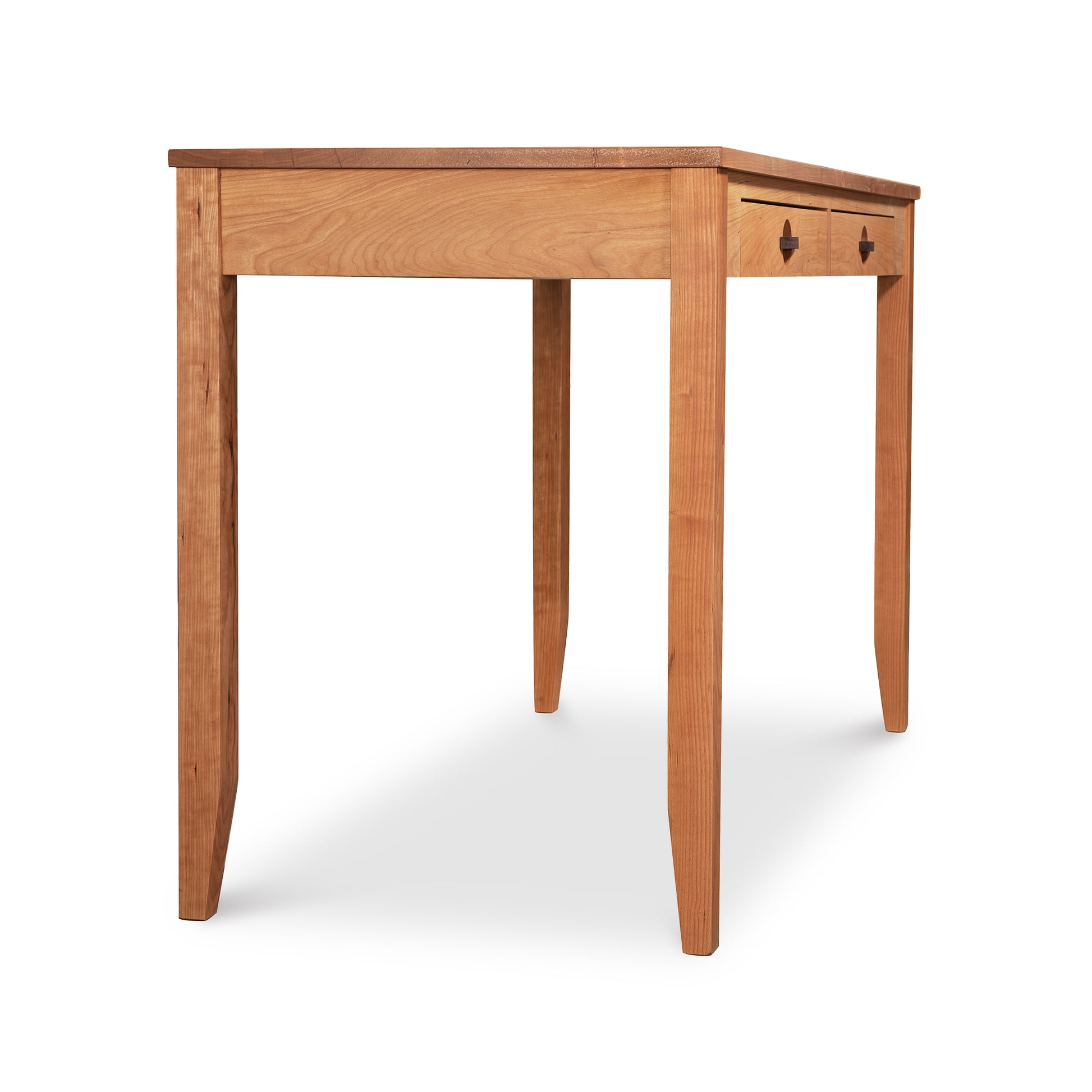 A Ryegate Writing Desk by Maple Corner Woodworks with tapered legs and two drawers, isolated on a white background.