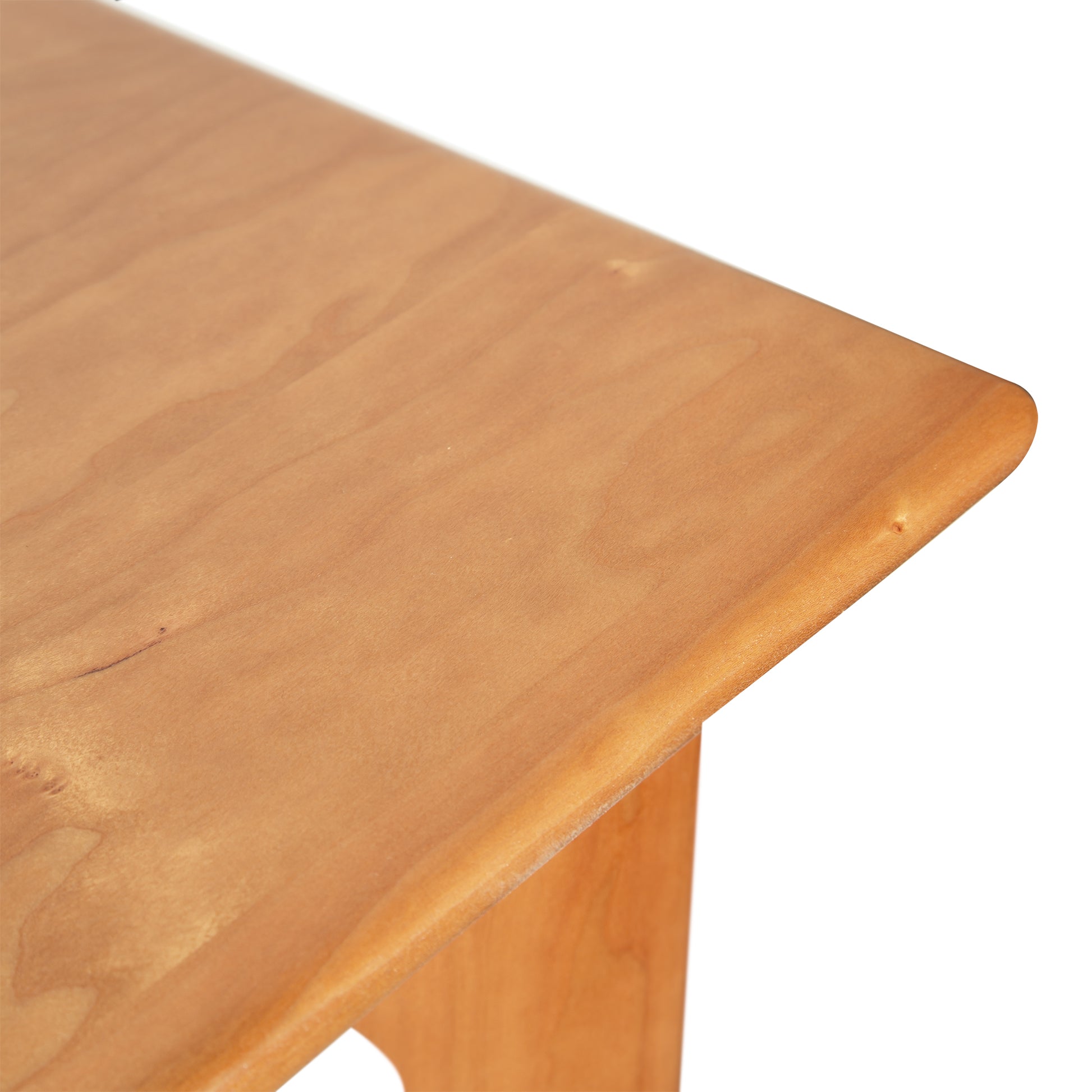 Sarah Large Desk by Copeland Furniture features a smooth light brown wood surface and handcrafted rounded corner, highlighting American-made quality.