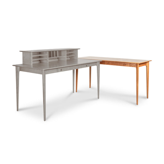 Copeland Furniture Sarah Return with Keyboard Tray in light brown seamlessly connects to a gray Shaker desk with hutch, forming an elegant workstation.