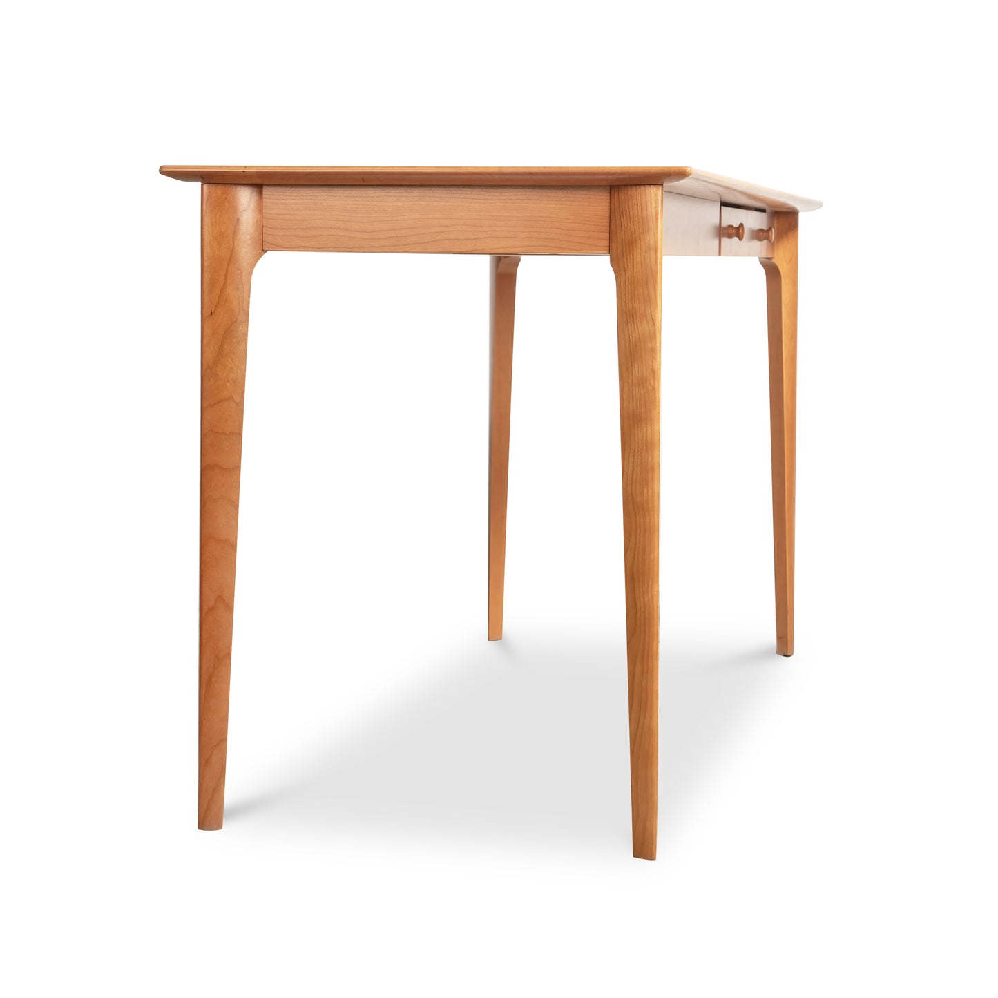 Sarah Return with Keyboard Tray by Copeland Furniture, featuring four straight legs and a rectangular top crafted in solid wood, shown at an angle.