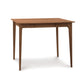 A Copeland Furniture Sarah Secretary Desk in a wood color with two legs and a drawer.