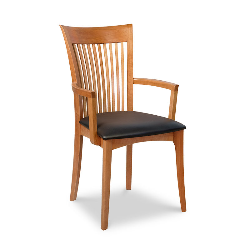 A wooden dining chair with black leather seat.