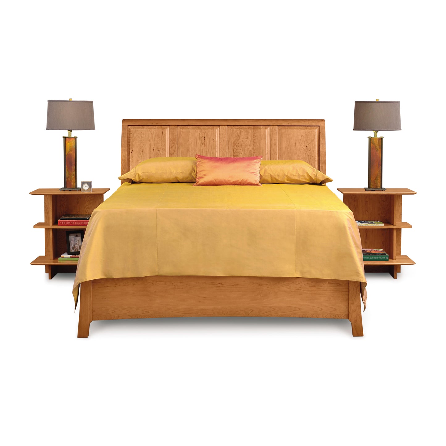 A Sarah Sleigh Storage Bed with matching nightstands and lamps, designed in the Shaker-style Copeland Furniture Sarah Bedroom Furniture line, dressed with a yellow bedspread and a decorative pink pillow, isolated on a white background.